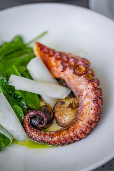 Tender grilled seafood paired with crisp root vegetables