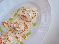 Seared ocean scallops with delicate herb garnishing and roe