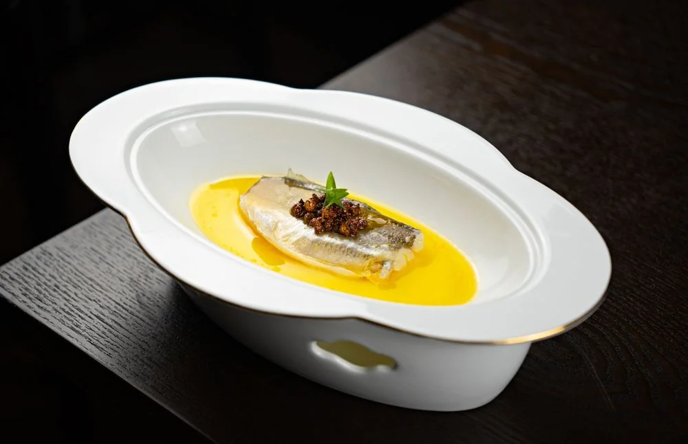Elegantly plated Canadian seafood with refined reduction in a dining room setting