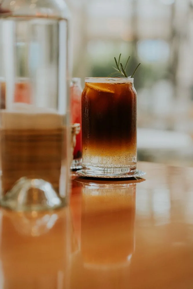 Specialty cold brew iced coffee with herbal garnish
