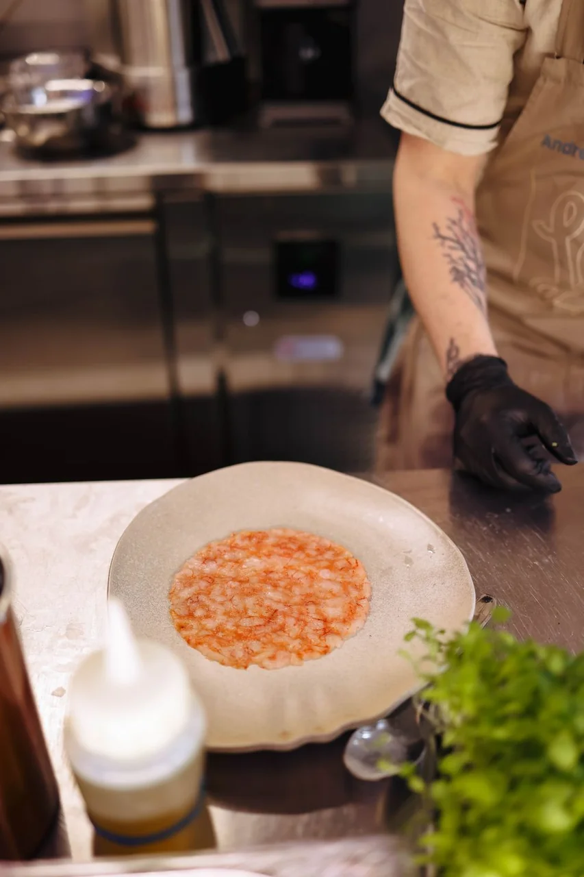 Culinary team preparing seafood tartare in kitchen