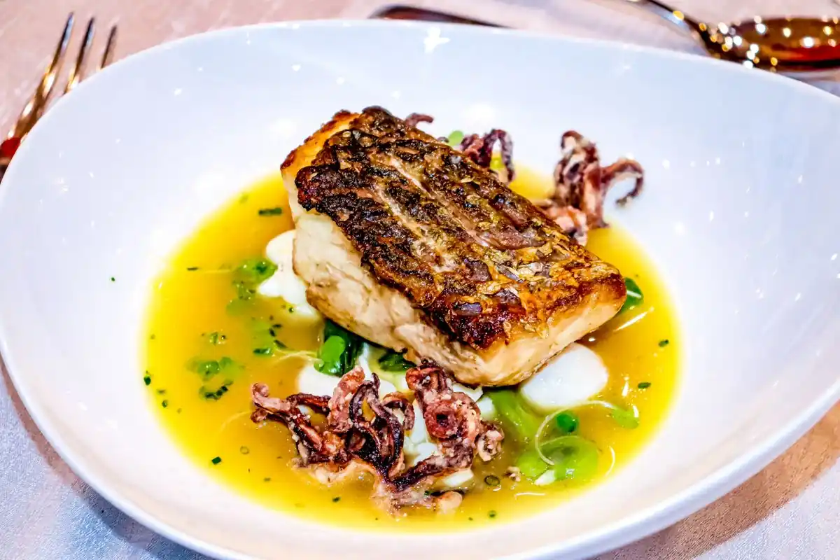 Seared fish with squid and delicate saffron reduction